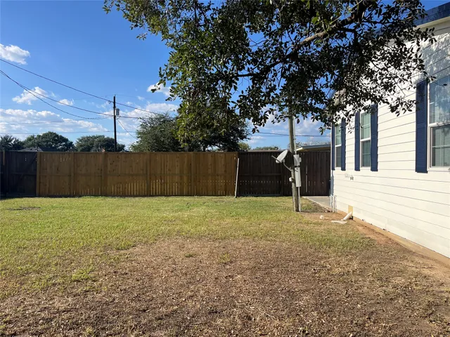 a view of a backyard with large trees