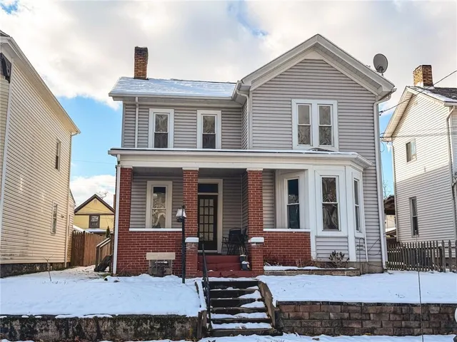 a front view of a house with a lots of windows