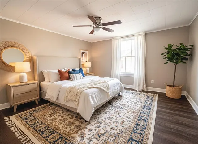 a bedroom with a large bed and a chandelier