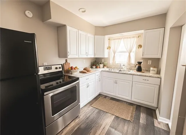 a kitchen with a stove a sink and a window