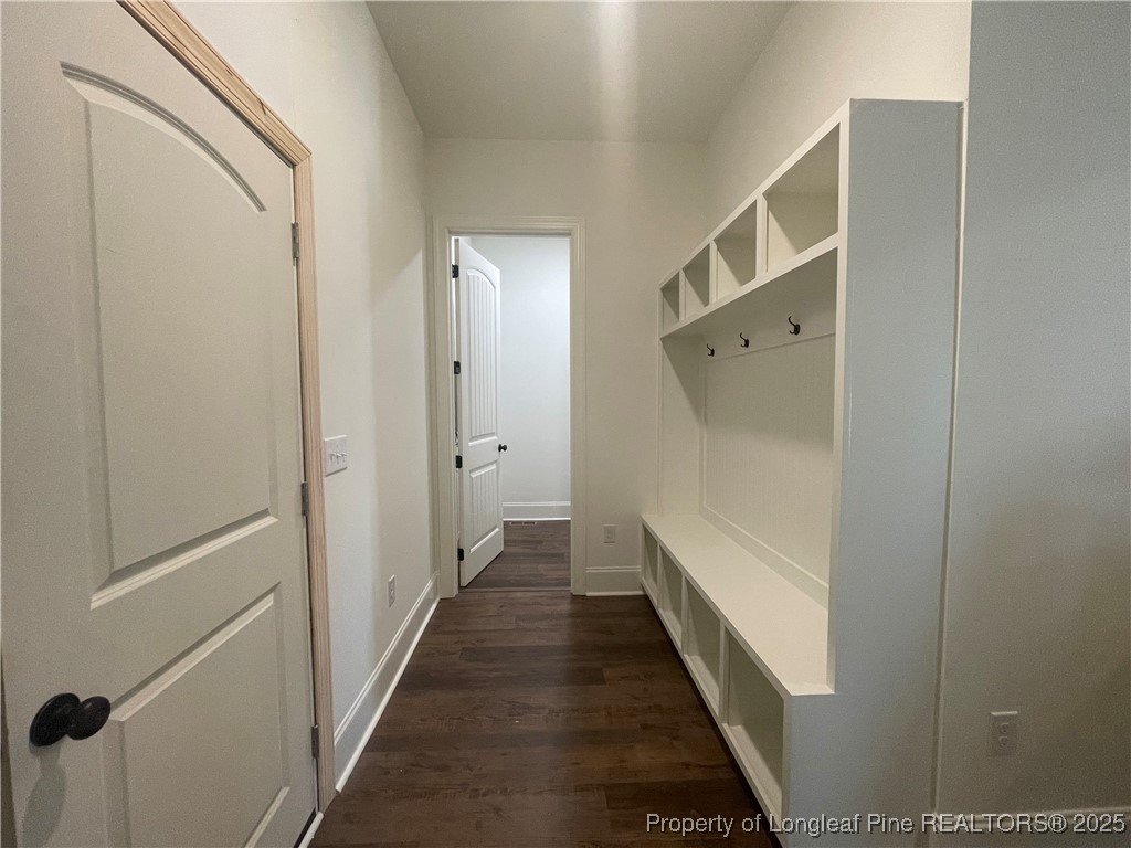 484 Falling Water Road Spring Lake, NC 28390 - Photo 14 of 18 a view of a hallway with wooden floor and staircase