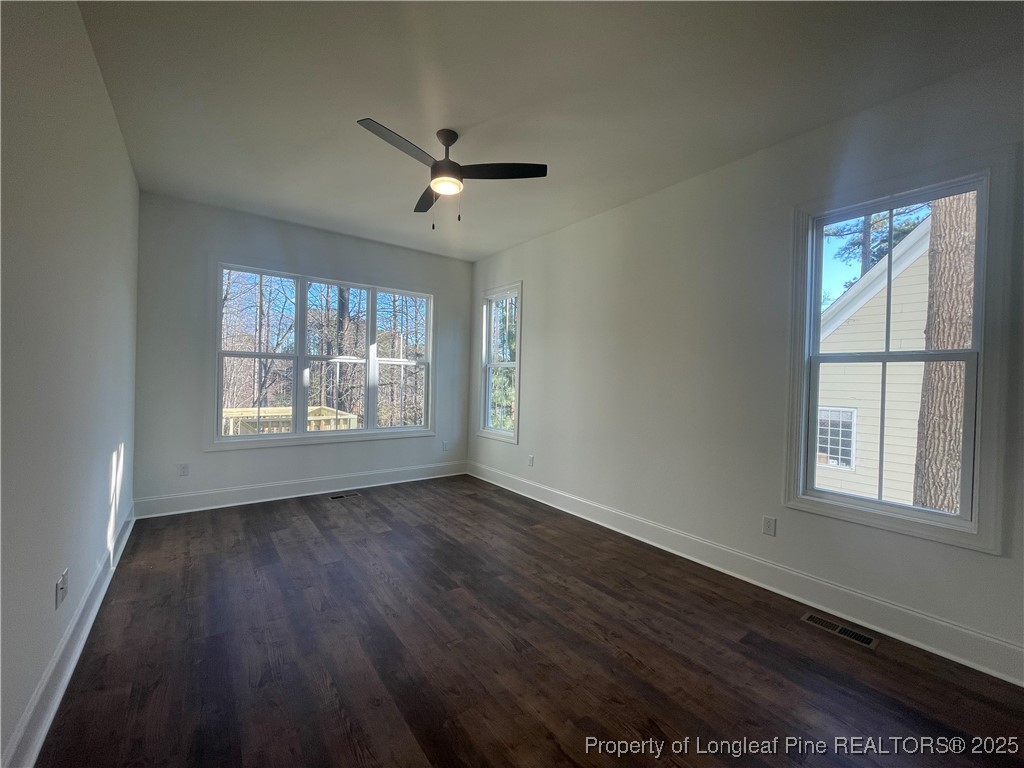 484 Falling Water Road Spring Lake, NC 28390 - Photo 15 of 18 a view of an empty room with wooden floor and a window