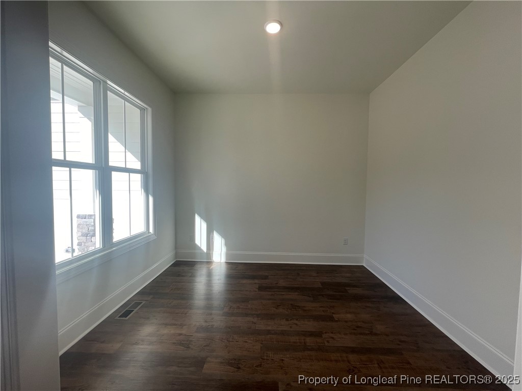 484 Falling Water Road Spring Lake, NC 28390 - Photo 16 of 18 an empty room with wooden floor and windows