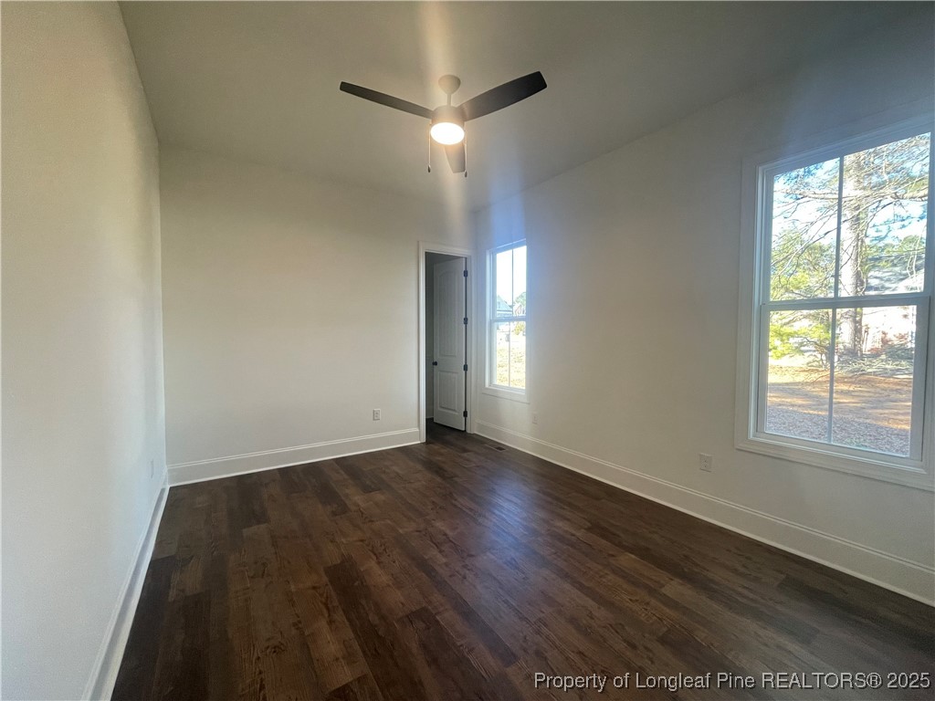 484 Falling Water Road Spring Lake, NC 28390 - Photo 17 of 18 an empty room with wooden floor and windows