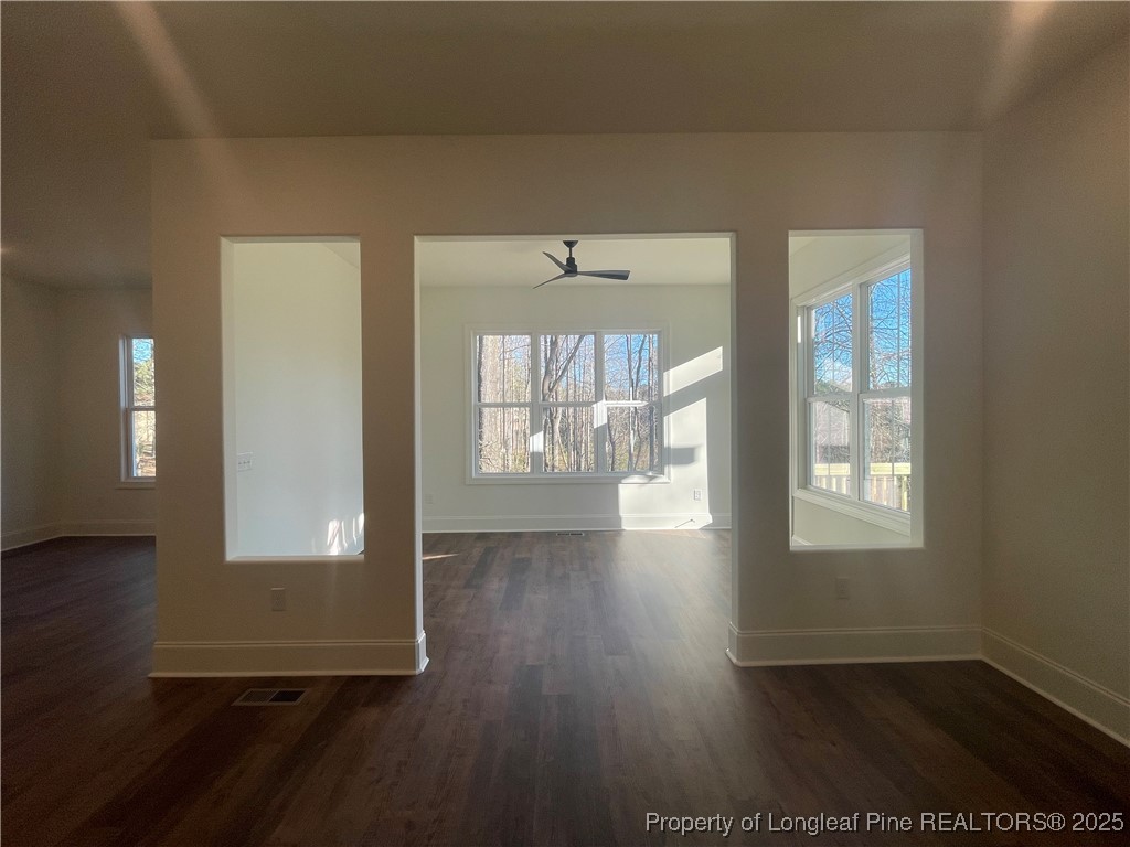 484 Falling Water Road Spring Lake, NC 28390 - Photo 7 of 18 wooden floor in an empty room with a window
