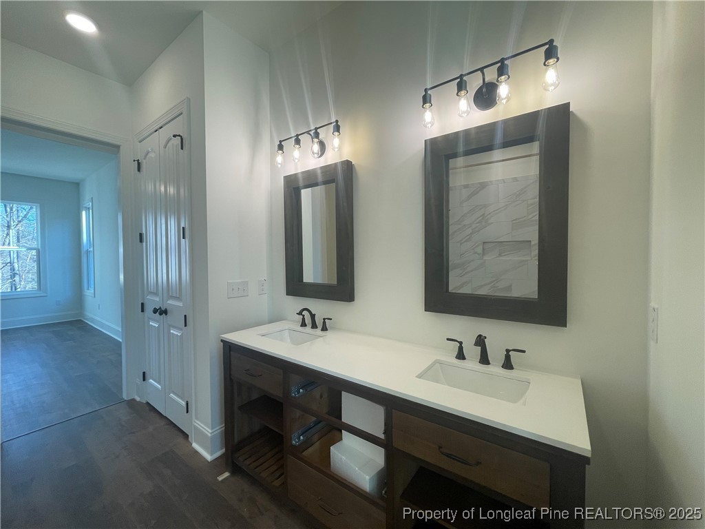 484 Falling Water Road Spring Lake, NC 28390 - Photo 10 of 18 a bathroom with double vanity sinks and a mirror