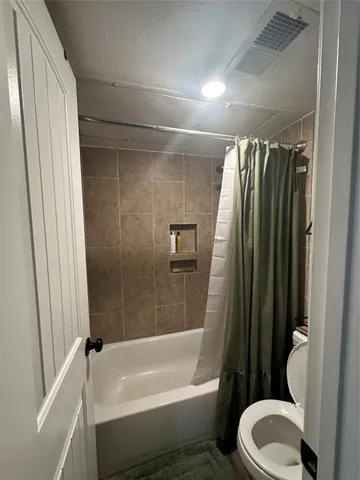 a bathroom with a toilet and a bathtub