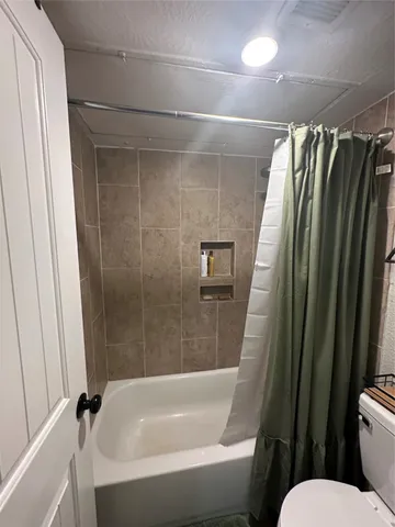 a bathroom with a shower and a toilet