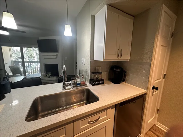 a kitchen with a sink and a refrigerator