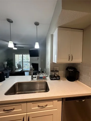 a kitchen with a sink a counter space and cabinets