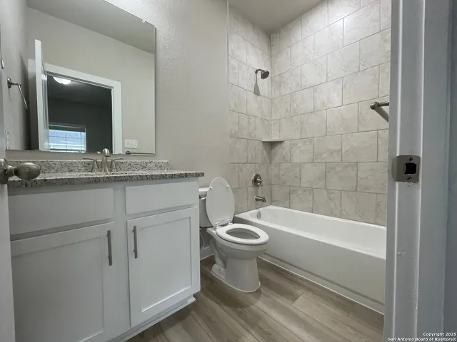 a bathroom with a sink a toilet and bathtub