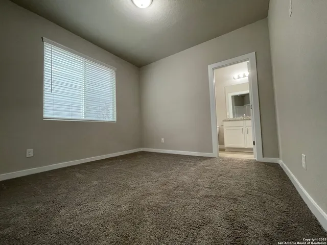 an empty room with a empty space and windows