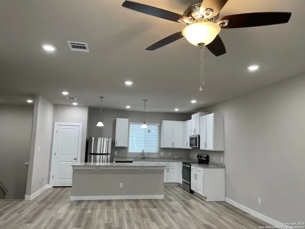 a view of kitchen with sink microwave and stove