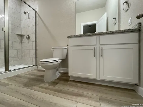 a bathroom with a toilet sink and shower