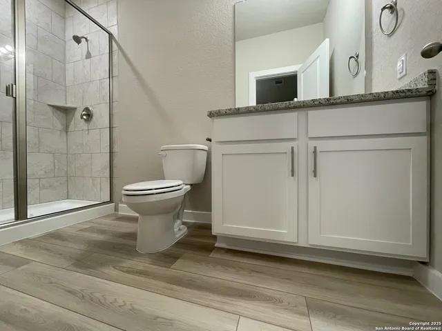 a bathroom with a toilet sink and shower