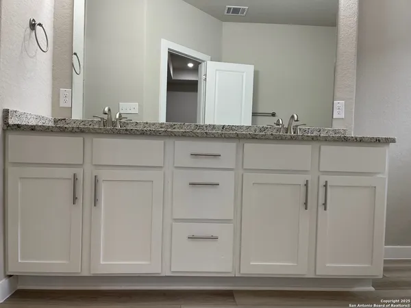 a bathroom with a sink and mirror