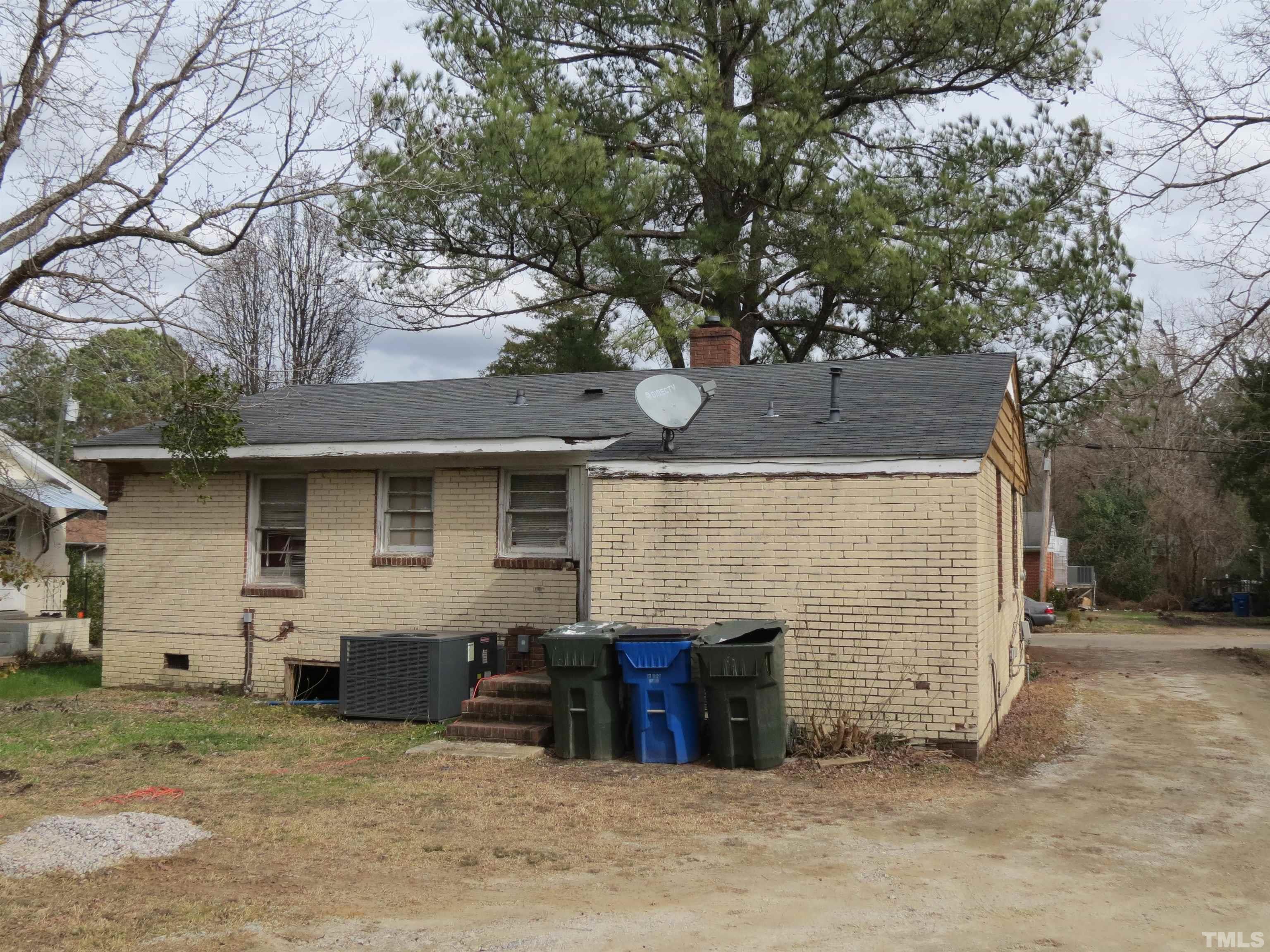 1816 Charles Street Raleigh, NC 27610 - Photo 2 of 4 a view of a house with large tree and wooden fence