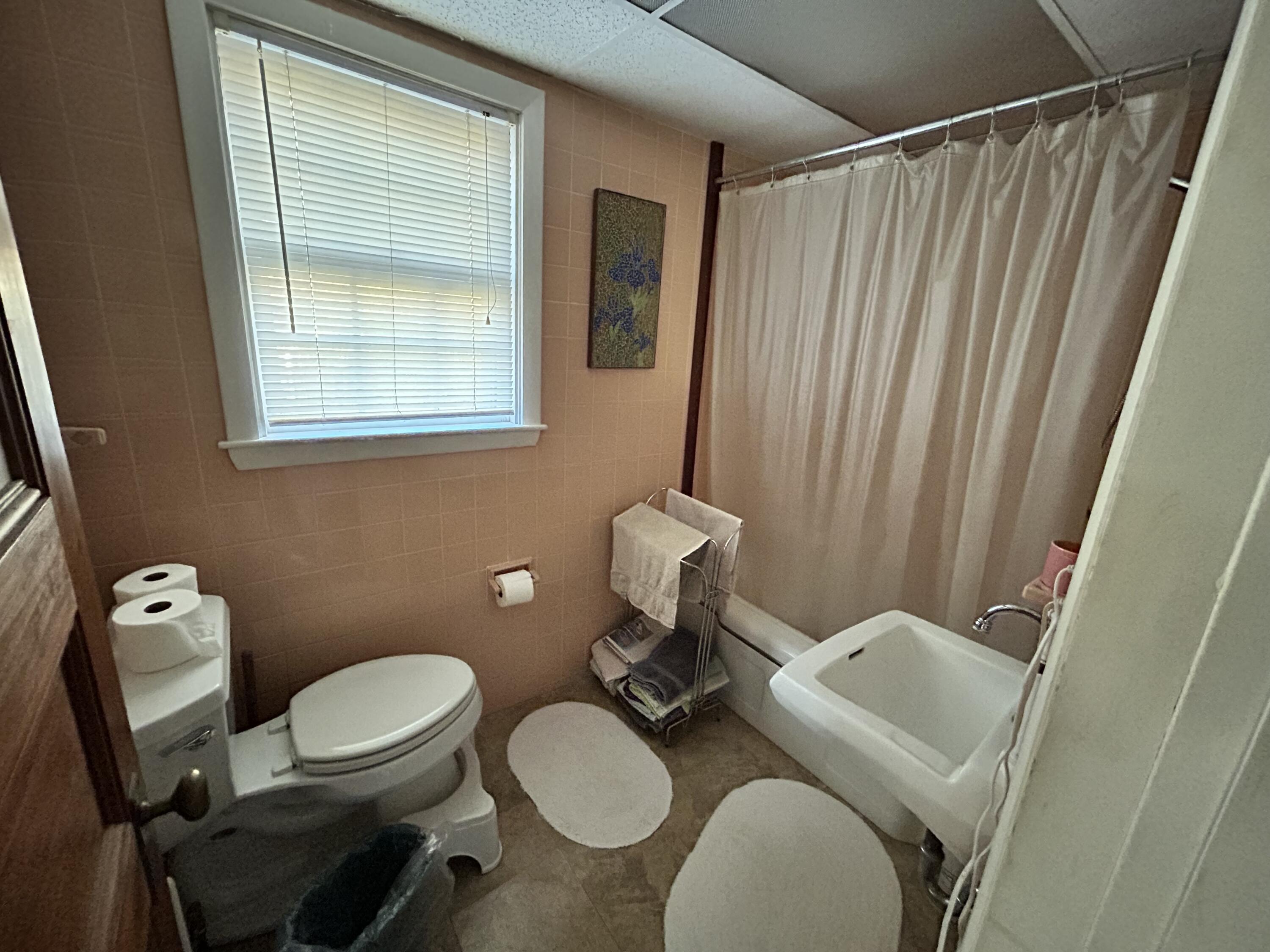 10 Benson Road Truro, MA 02666 - Photo 16 of 36 a bathroom with a toilet sink and mirror