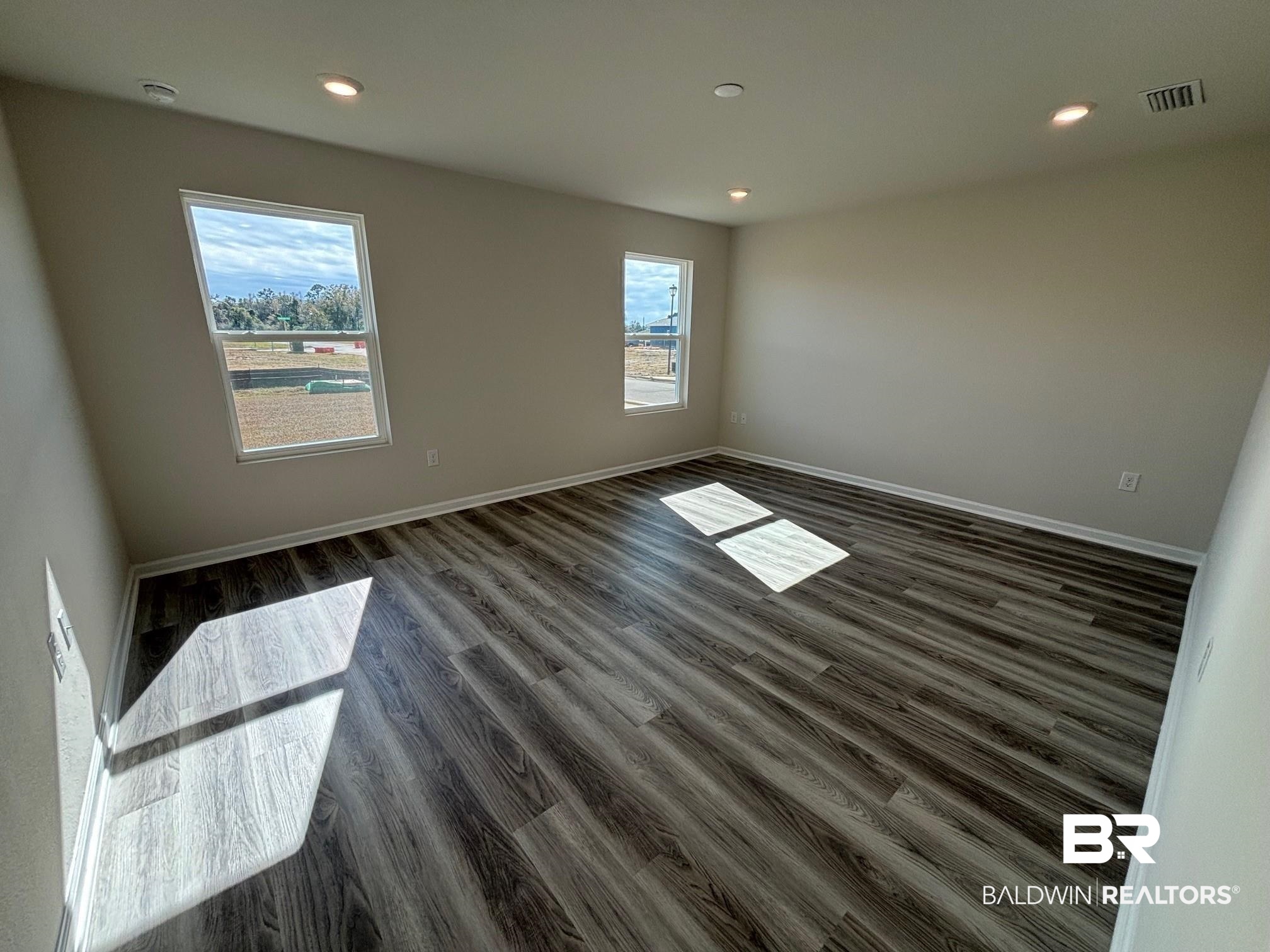 22044 Aleutian Avenue Foley, AL 36535 - Photo 18 of 28 Unfurnished room with dark hardwood / wood-style flooring and a wealth of natural light