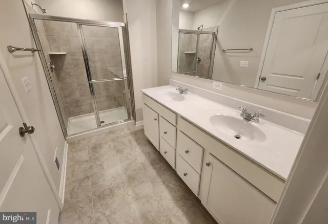 a bathroom with double vanity sink and a mirror