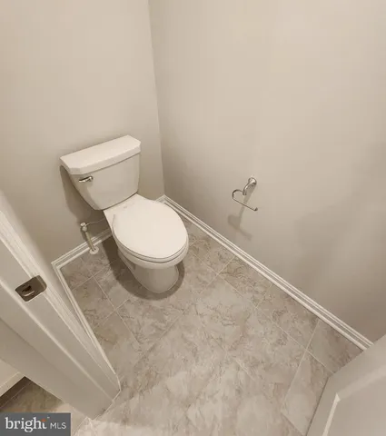 a white toilet sitting next to a white sink