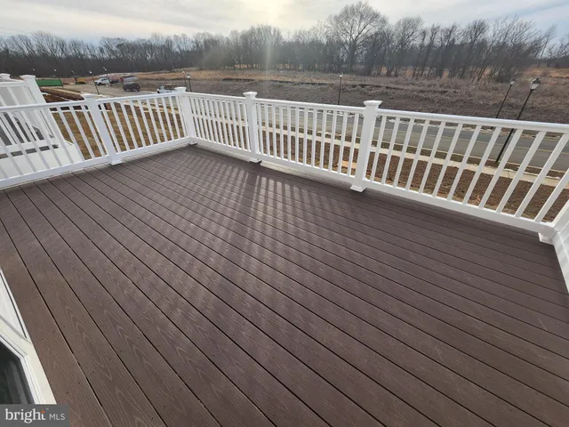 a view of deck with wooden floor and fence
