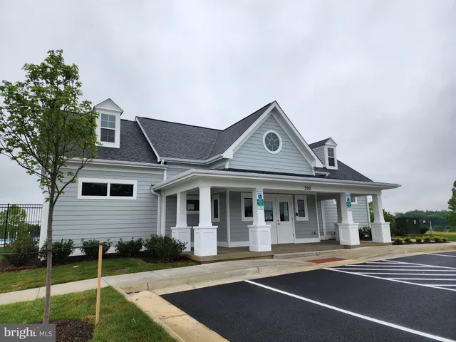 a view of swimming pool with outdoor seating and house in the background