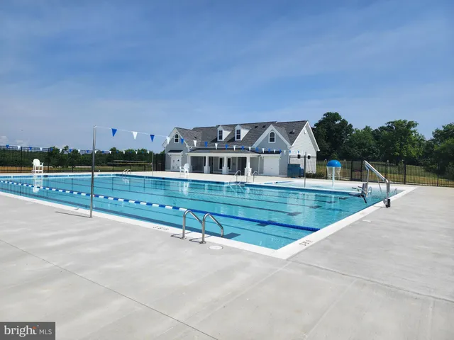 a view of a swimming pool with a yard