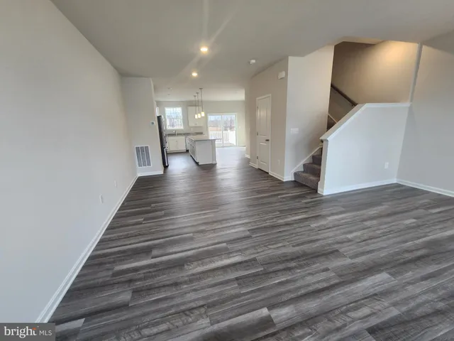a view of a room with wooden floor