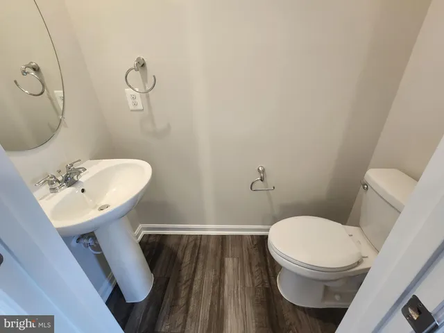 a white toilet sitting next to a bathroom sink