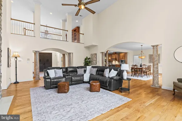 a dining room with furniture a chandelier and wooden floor