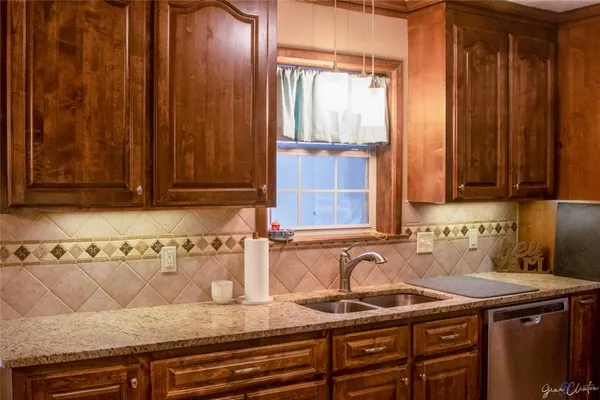 a kitchen with stainless steel appliances granite countertop a stove and a microwave
