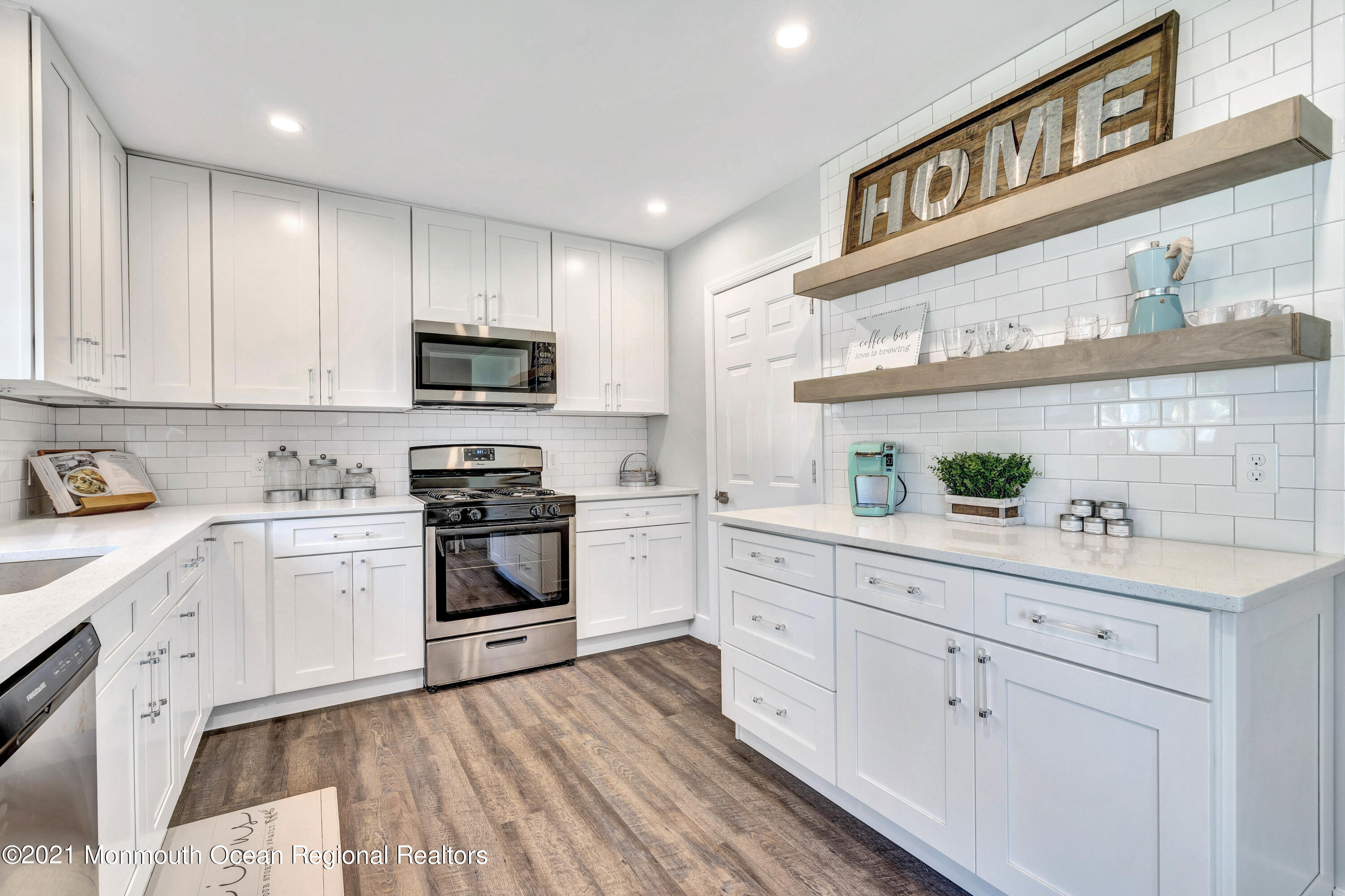 177 Topside Road Manahawkin, NJ 08050 - Photo 12 of 30 a kitchen with granite countertop white cabinets and stainless steel appliances