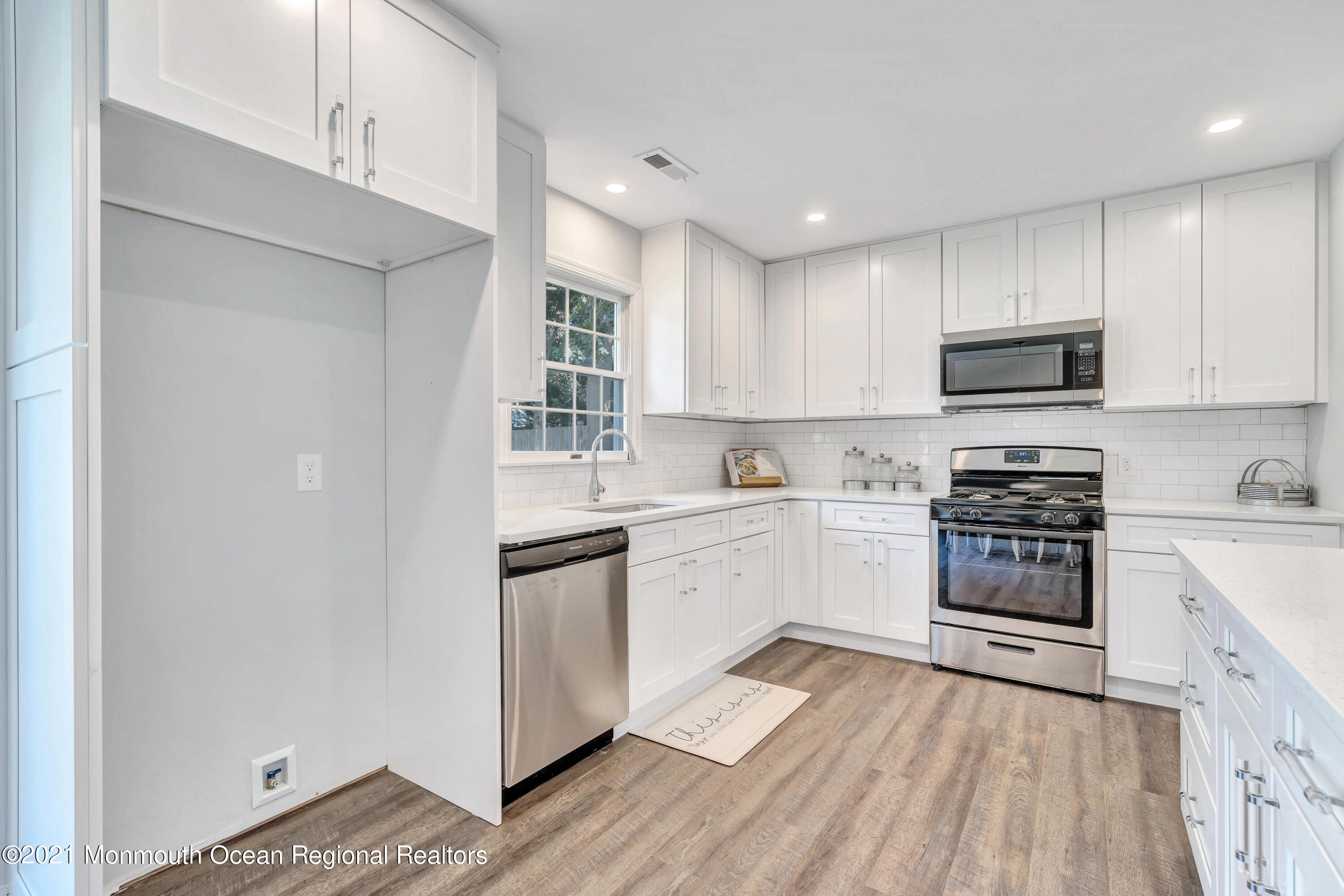 177 Topside Road Manahawkin, NJ 08050 - Photo 13 of 30 a kitchen with stainless steel appliances granite countertop a stove top oven a sink and white cabinets