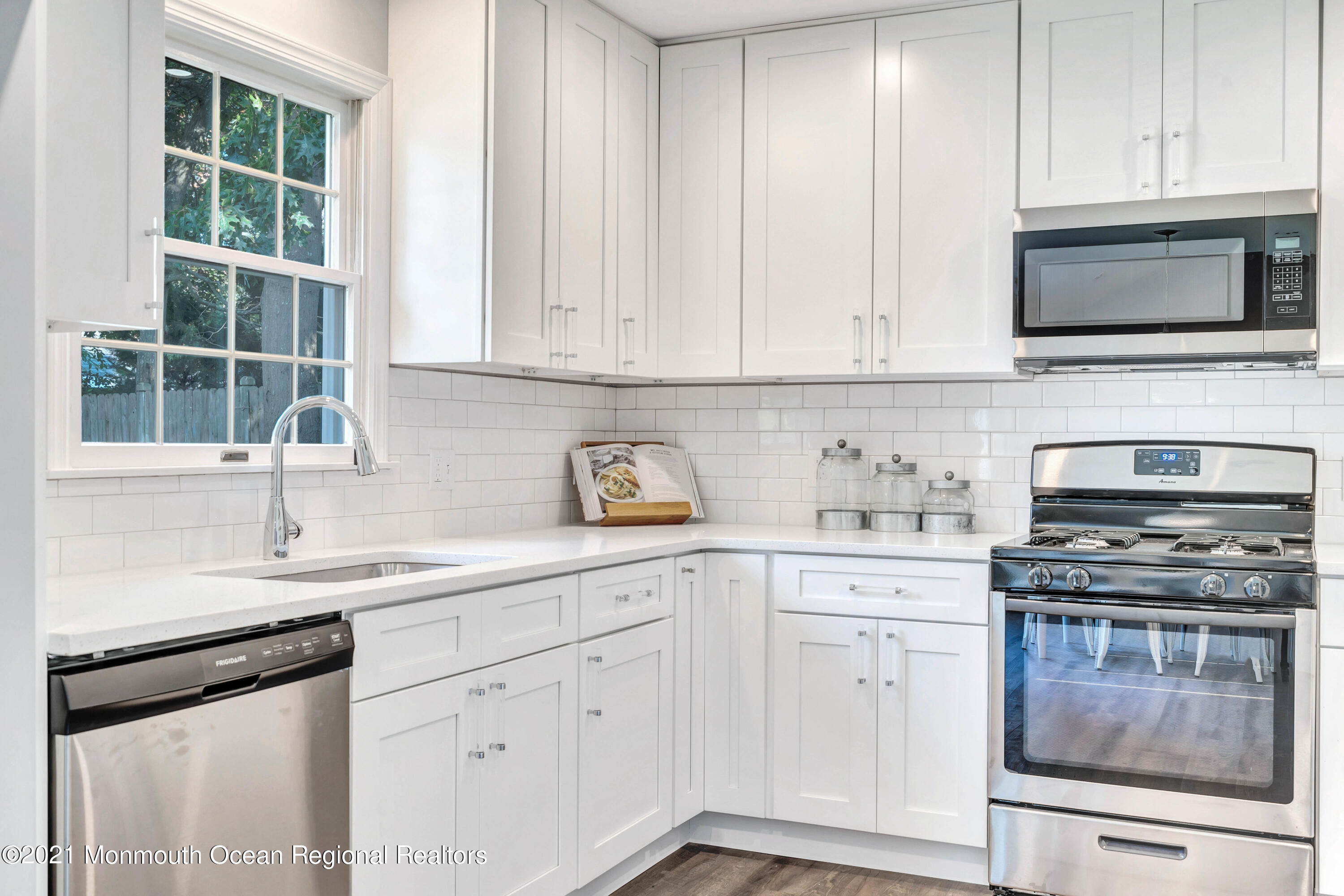 177 Topside Road Manahawkin, NJ 08050 - Photo 14 of 30 a kitchen with white cabinets and appliances