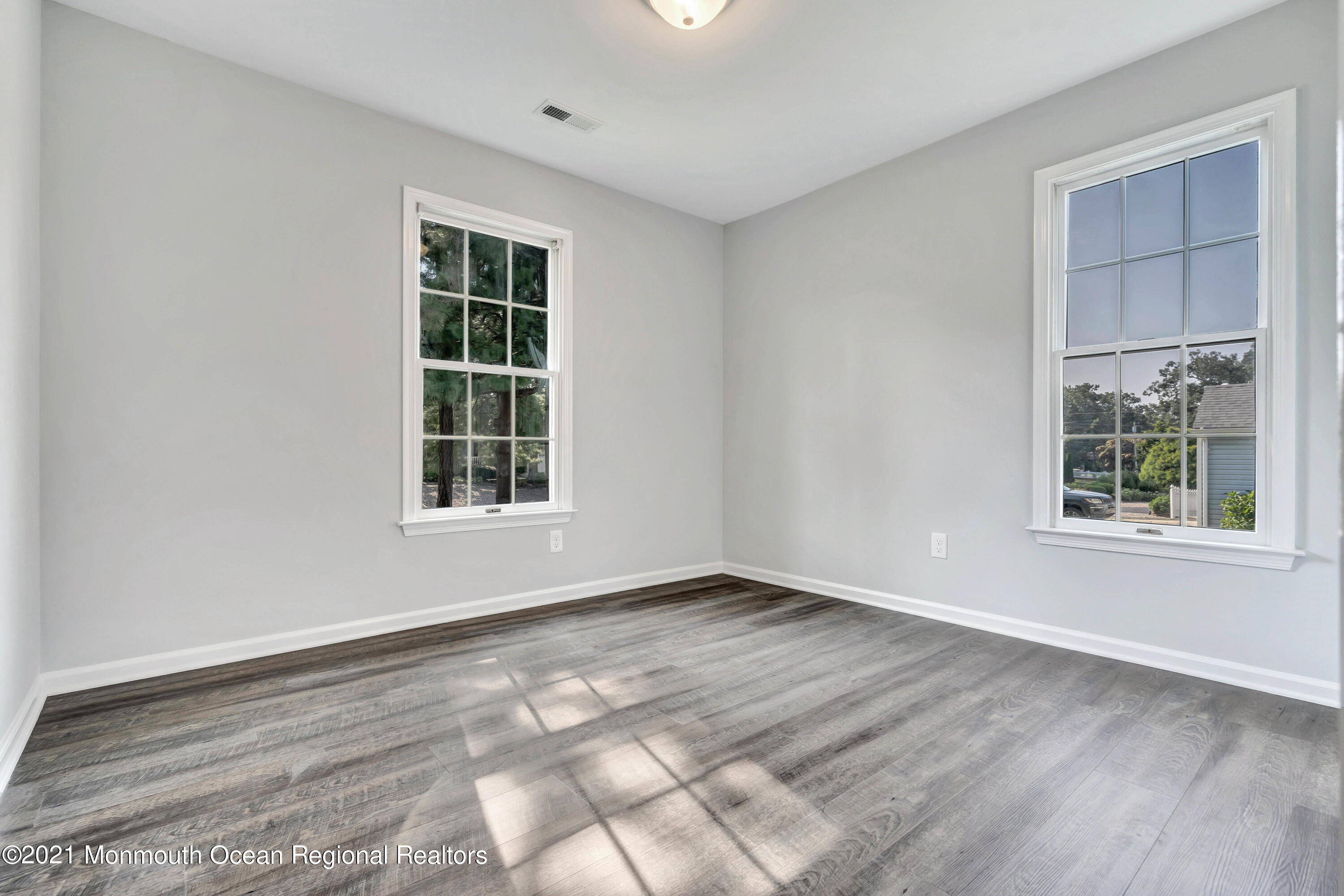 177 Topside Road Manahawkin, NJ 08050 - Photo 20 of 30 a view of an empty room with wooden floor and a window