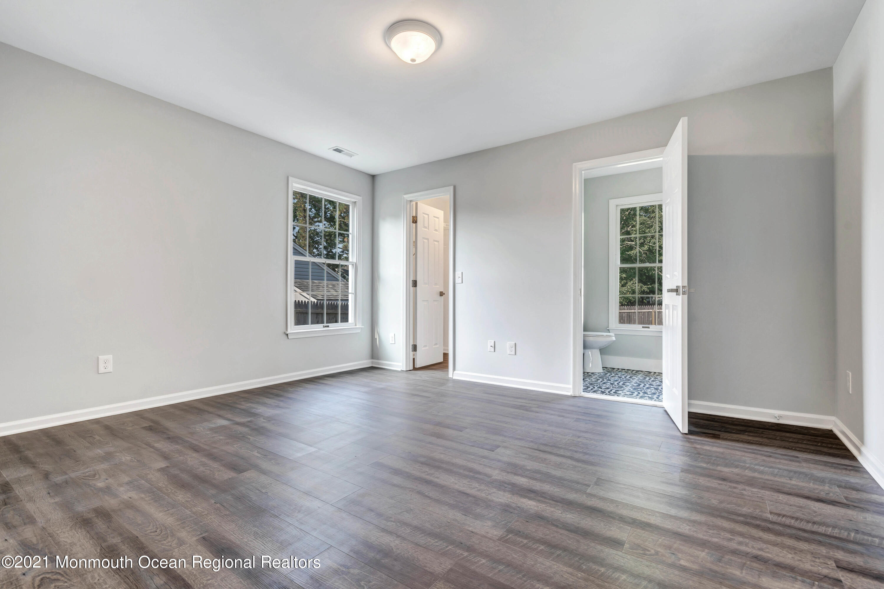 177 Topside Road Manahawkin, NJ 08050 - Photo 21 of 30 an empty room with wooden floor and windows