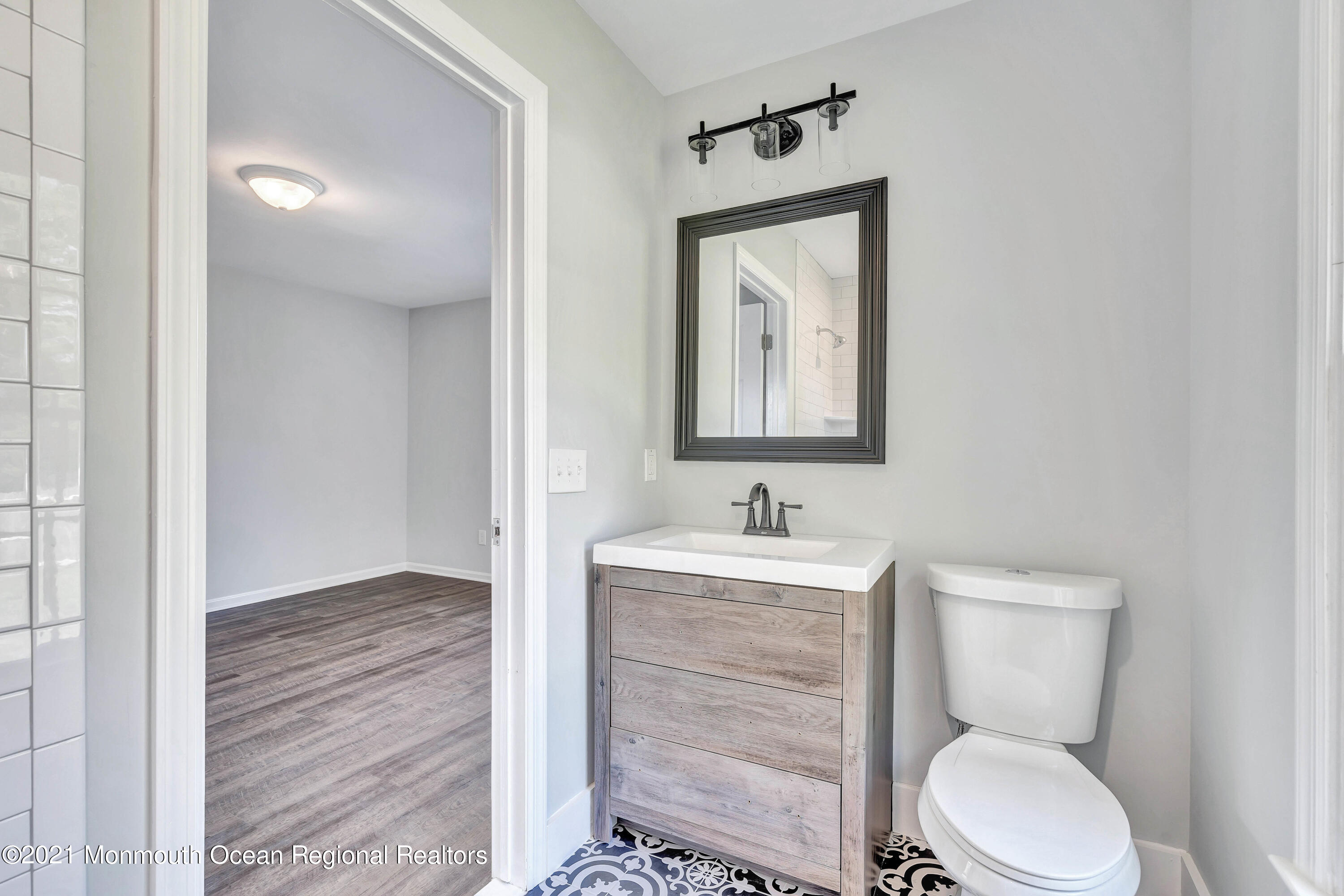 177 Topside Road Manahawkin, NJ 08050 - Photo 23 of 30 a bathroom with a toilet a sink and mirror