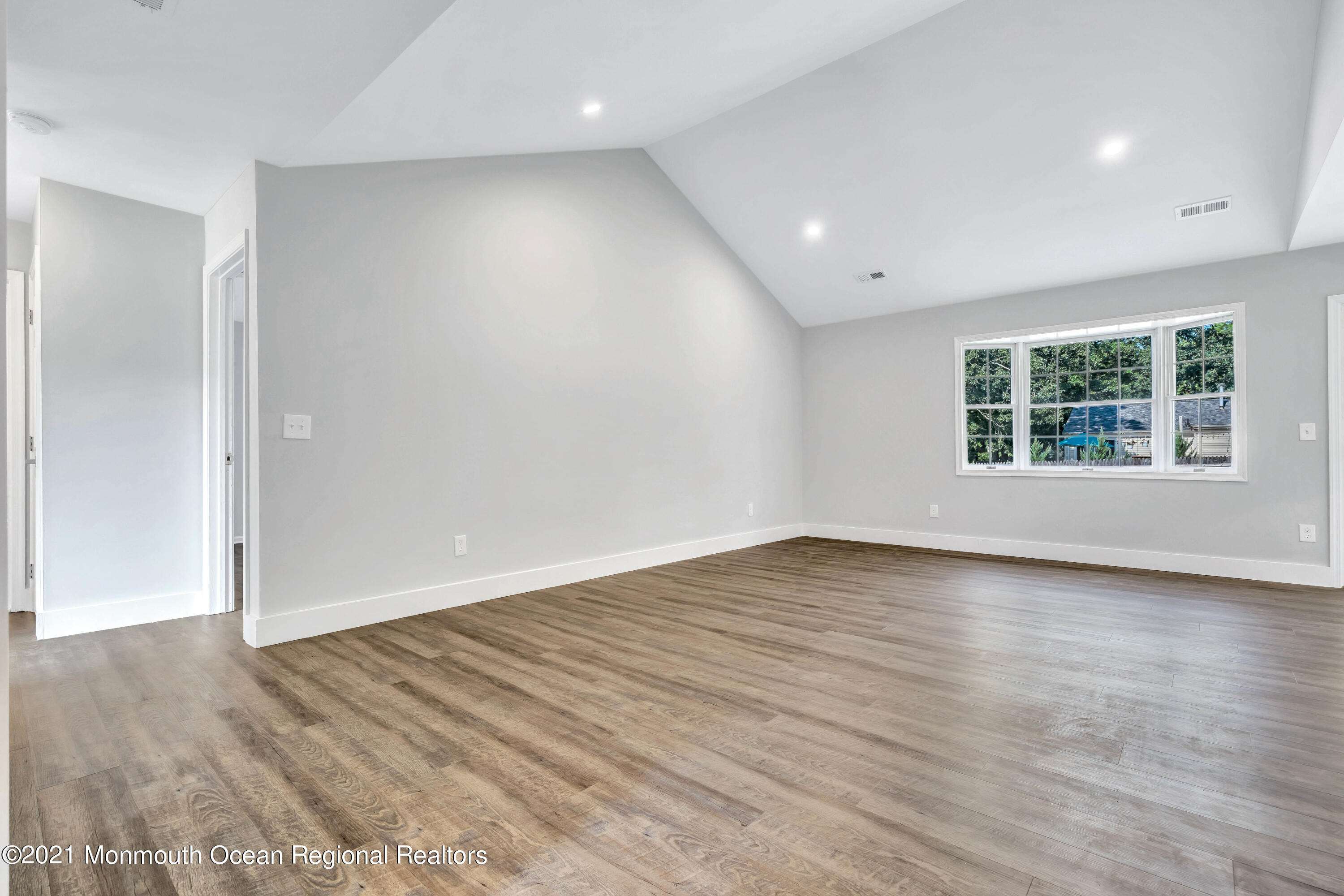 177 Topside Road Manahawkin, NJ 08050 - Photo 5 of 30 an empty room with wooden floor and windows