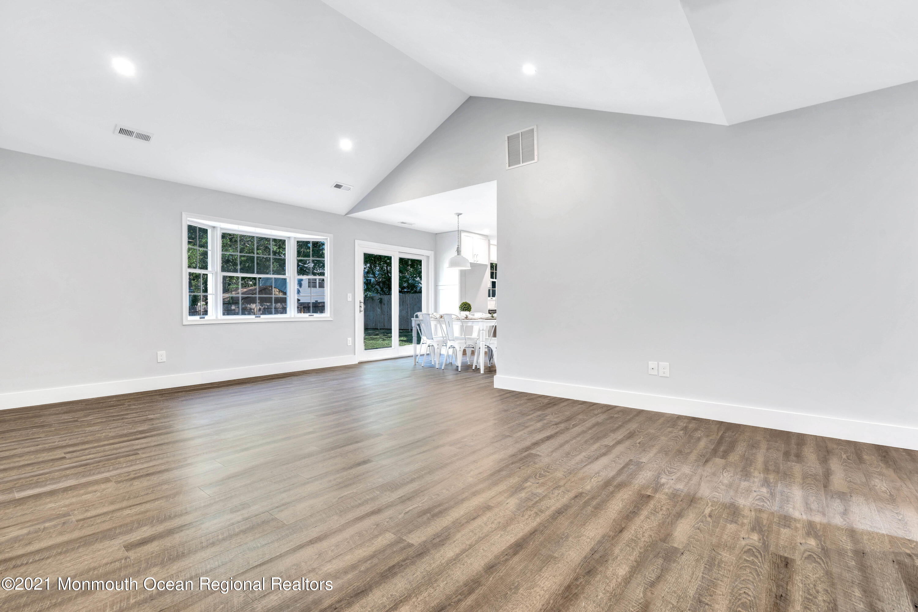 177 Topside Road Manahawkin, NJ 08050 - Photo 6 of 30 an empty room with wooden floor and windows