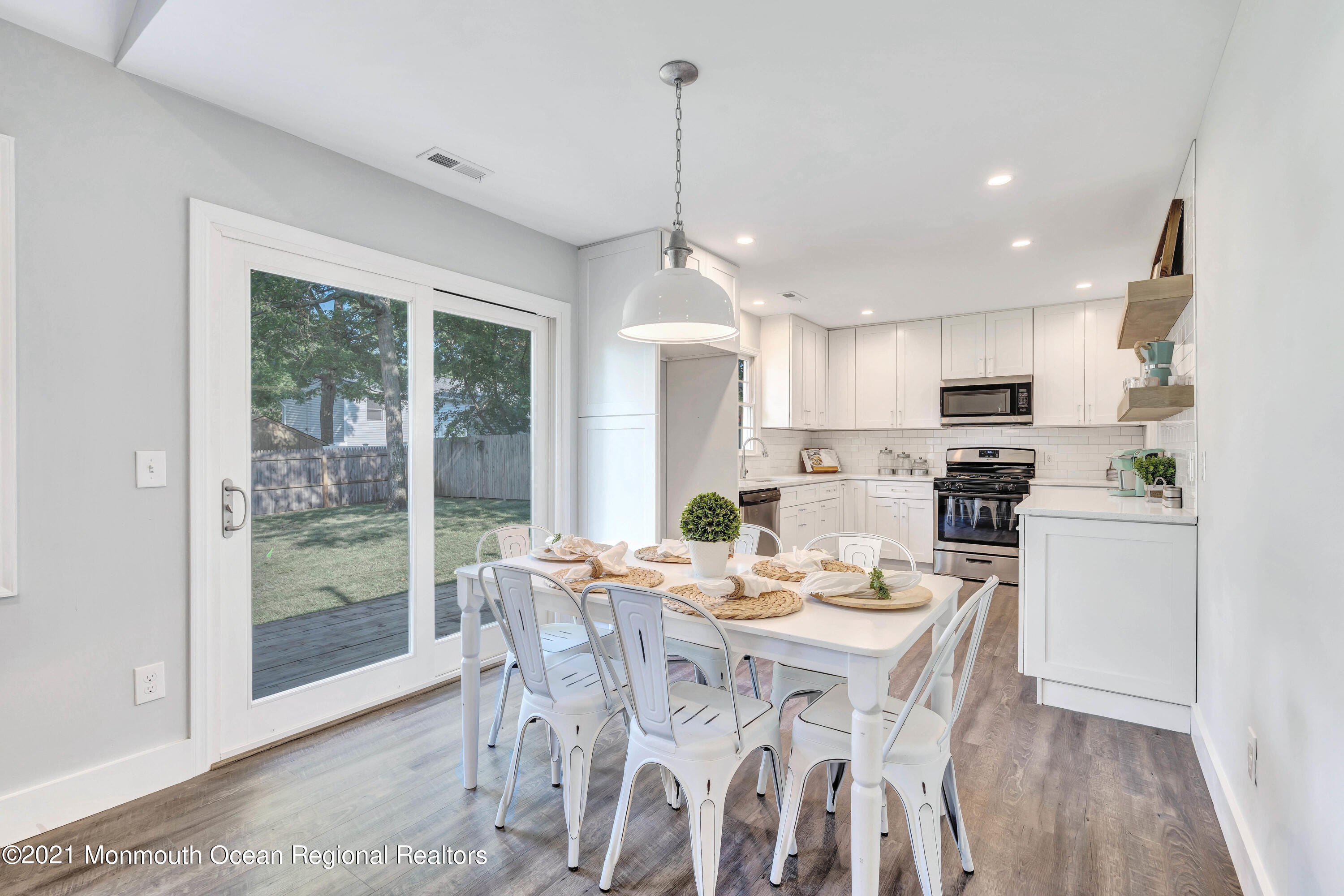 177 Topside Road Manahawkin, NJ 08050 - Photo 10 of 30 a view of a dining room with furniture large windows and wooden floor