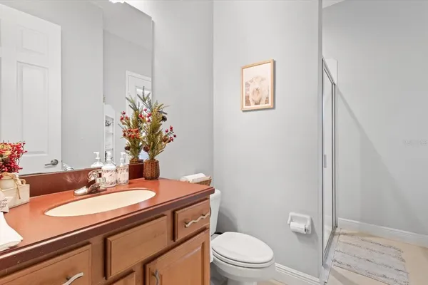 a bathroom with a sink toilet double vanity and shower