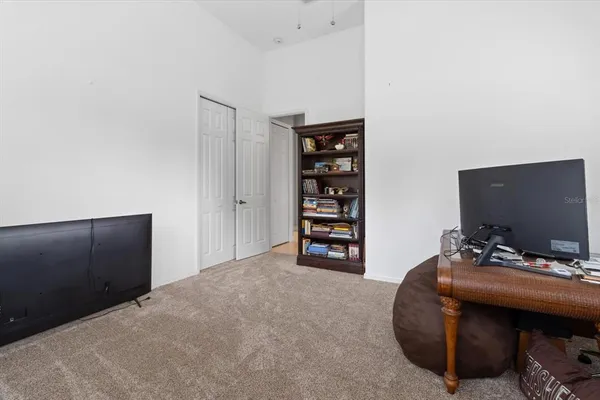 a bedroom with a bed and dresser with mirror