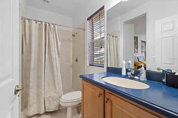 a large kitchen with a stove top oven a sink a counter space and cabinets
