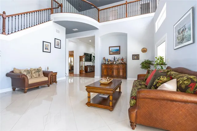 a living room with furniture and flowers