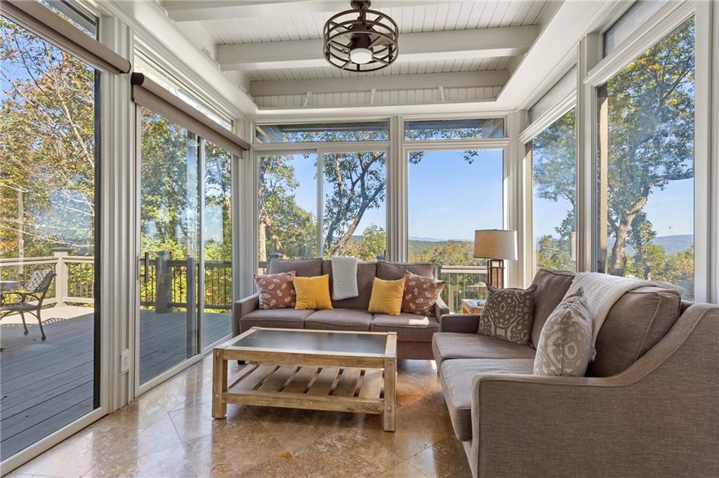 1319 Deer Run Ridge Jasper, GA 30143 - Photo 24 of 67 a living room with furniture a floor to ceiling window and floor to ceiling windows