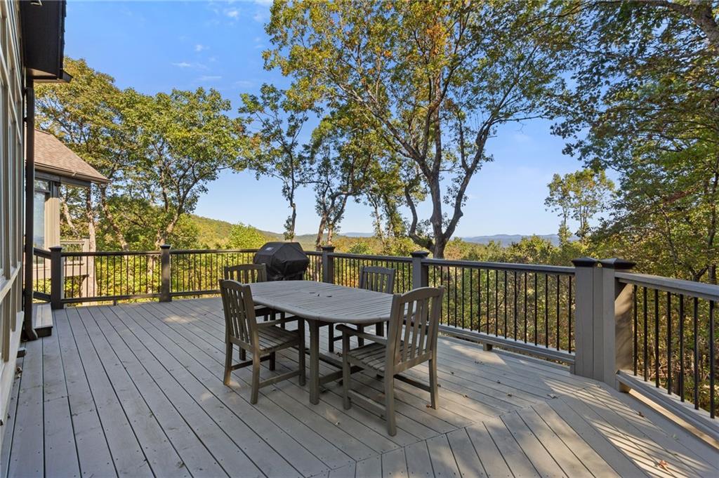1319 Deer Run Ridge Jasper, GA 30143 - Photo 46 of 67 a view of a deck with table and chairs and wooden floor