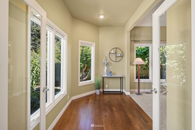 a view of a livingroom with wooden floor and furniture