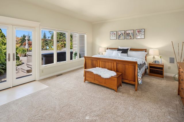 a spacious bedroom with a bed and a large window