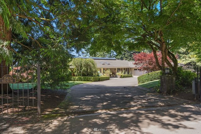 a view of a street with trees and houses